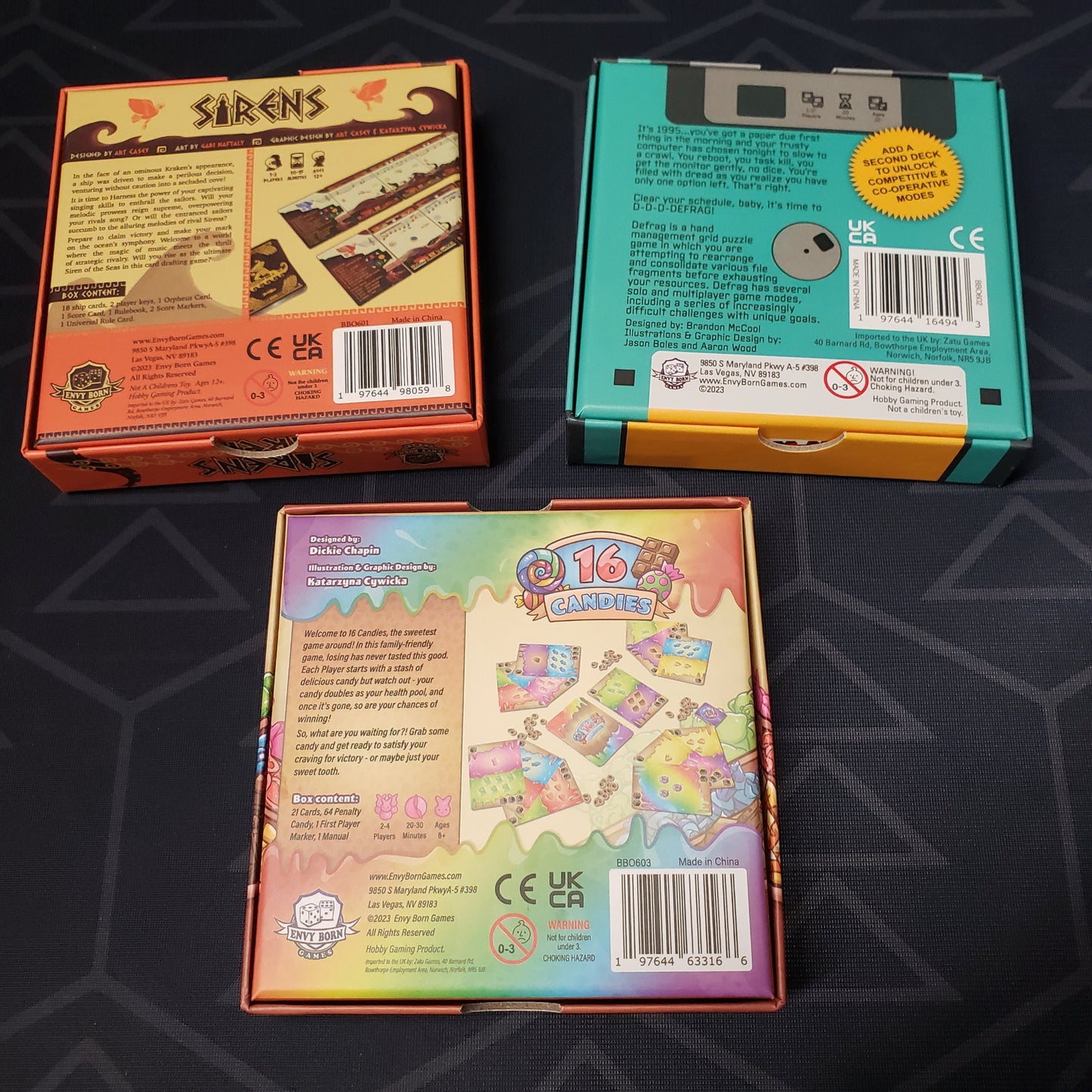 Image shows the back of the boxes of the three games that make up the Tiny Game Series: Volume 1 set of board games