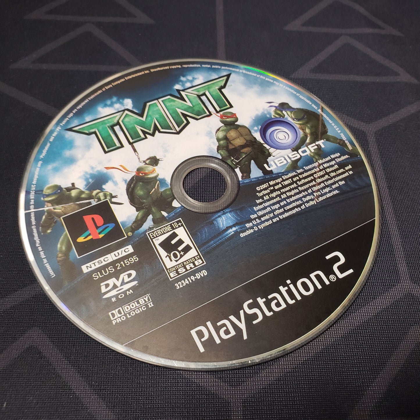 Image shows the label side of the game disc for the video game TMNT: Teenage Mutant Ninja Turtles for Playstation 2