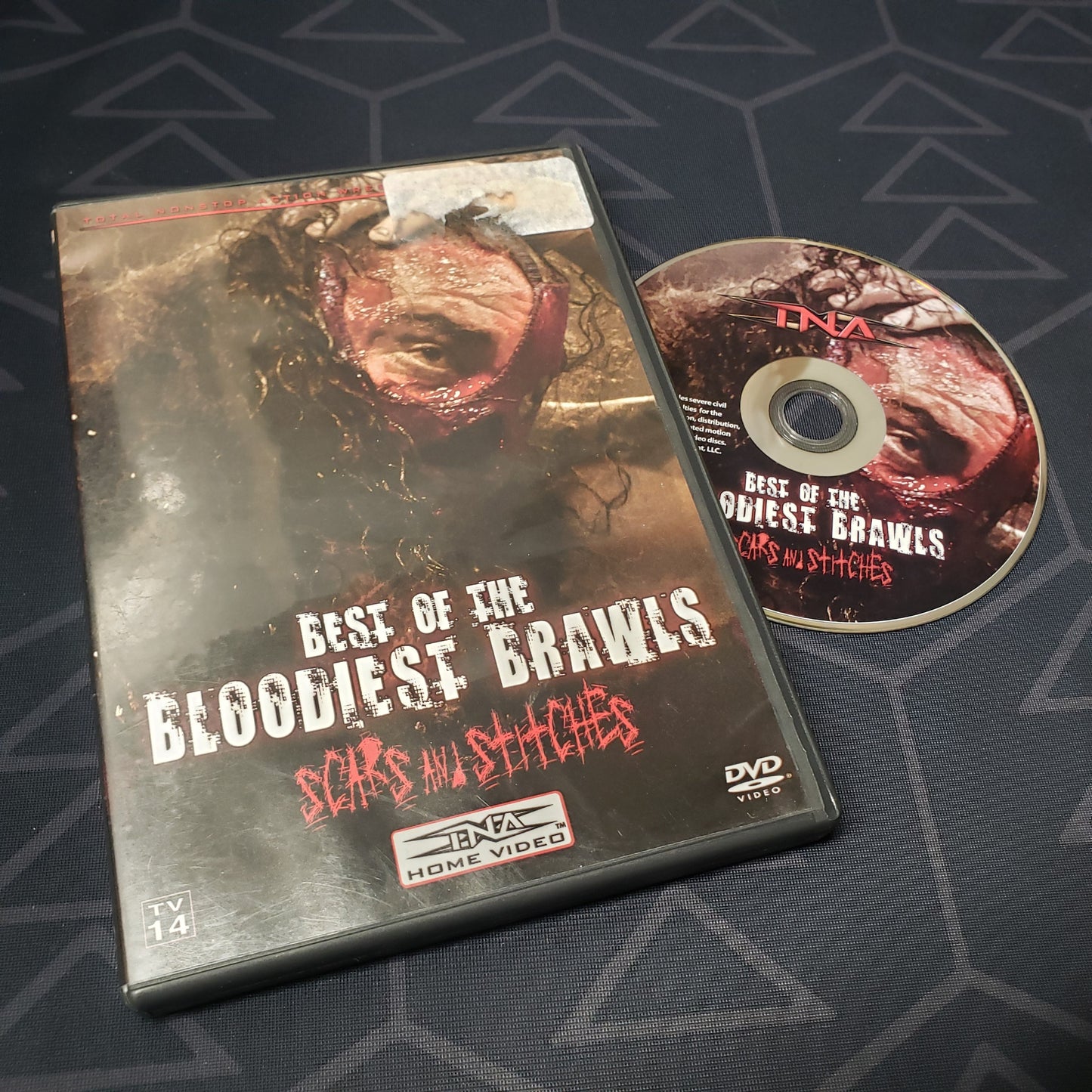 Image shows the case & disc for the movie TNA Wrestling: Best of the Bloodiest Brawls - Scars & Stitches on DVD