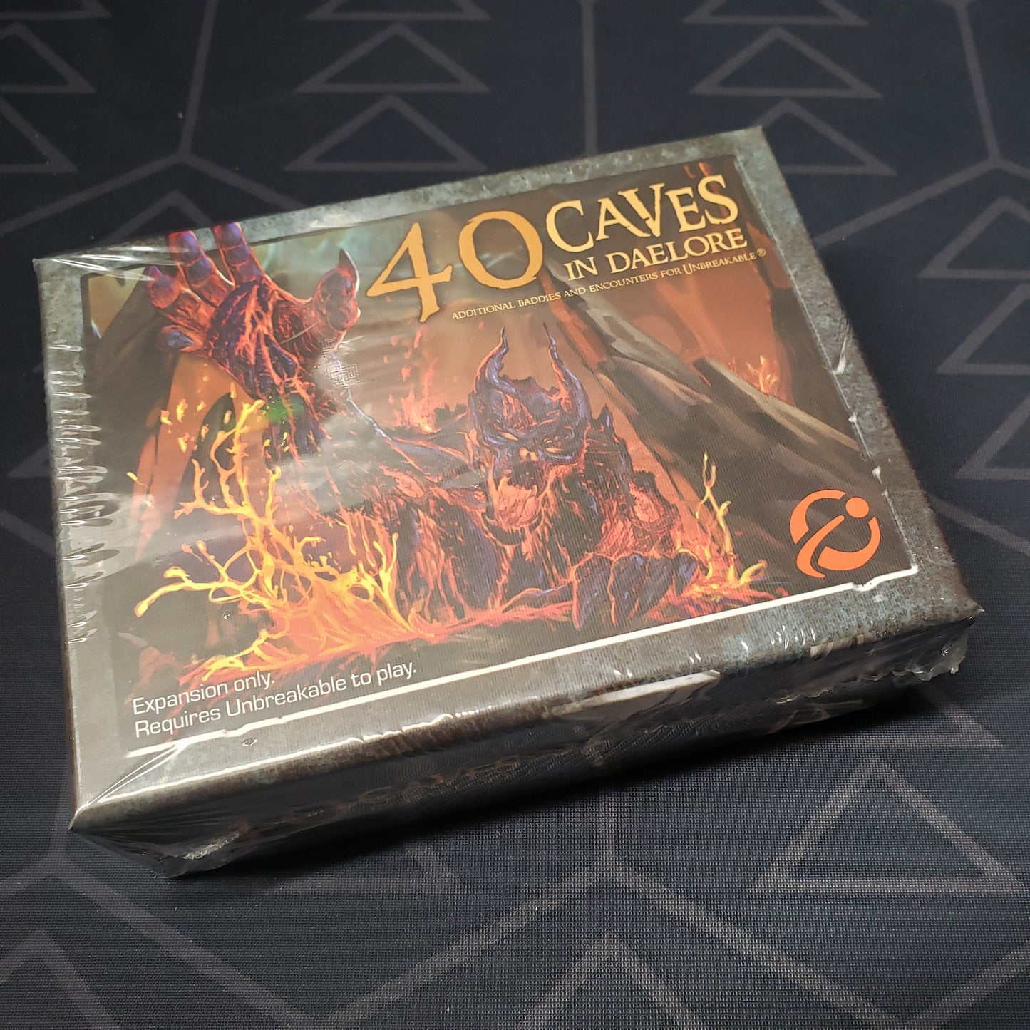 Image shows the front of the box for the 40 Caves in Daelore expansion for the board game Too Many Bones