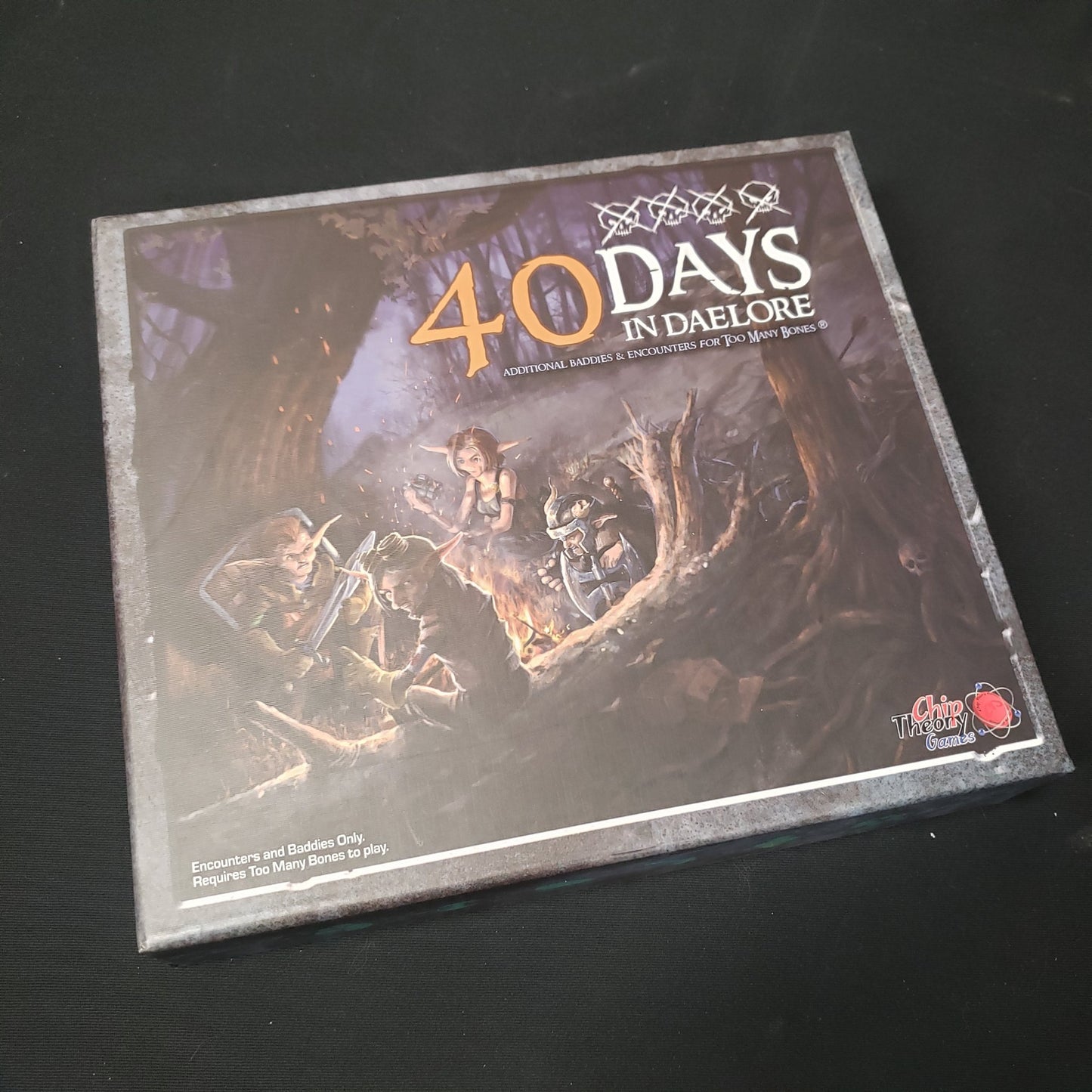 Image shows the front of the box for the 40 Days in Daelore expansion for the board game Too Many Bones
