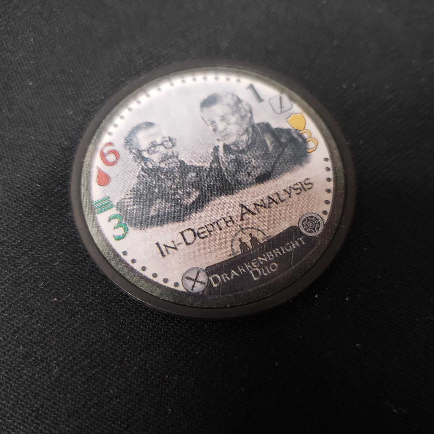 Image shows the Drakkenbright Duo promo expansion chip from the board game Too Many Bones