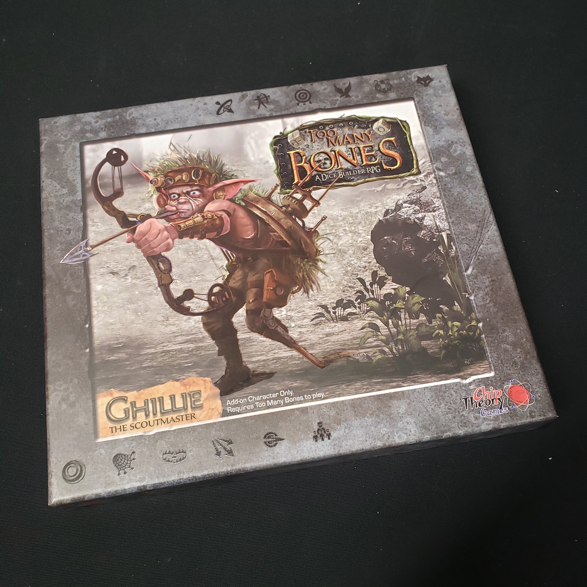 Image shows the front cover of the box for the Ghillie expansion from the board game Too Many Bones