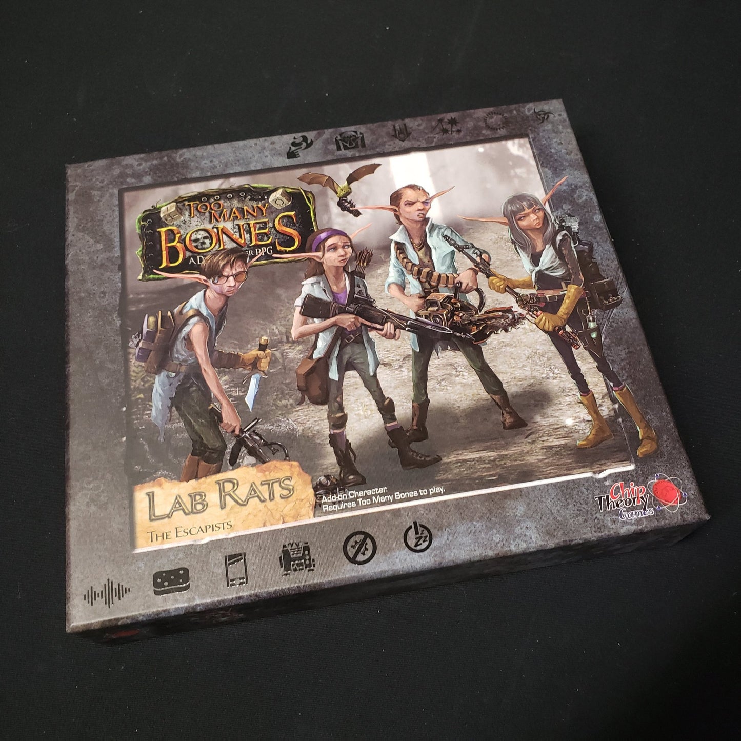 Image shows the front cover of the box for the Lab Rats expansion from the board game Too Many Bones