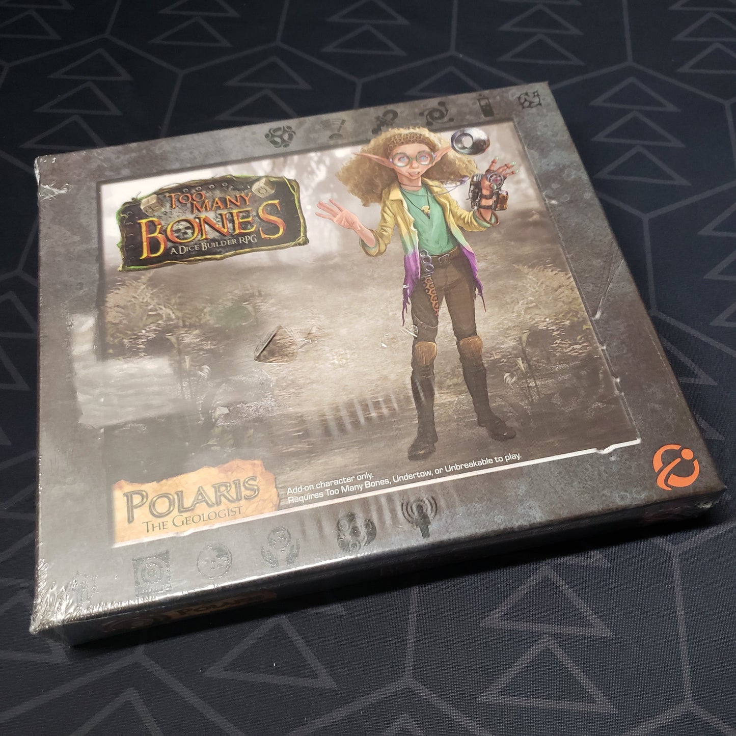 Image shows the front cover of the box for the Polaris expansion from the board game Too Many Bones