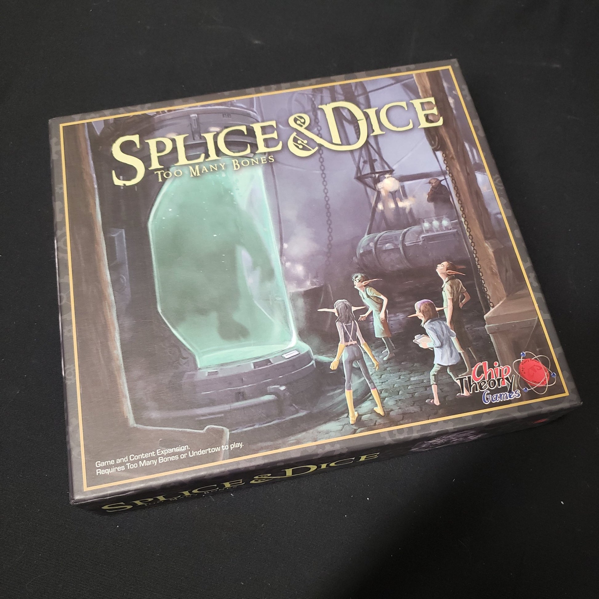 Image shows the front of the box for the Splice & Dice expansion for the board game Too Many Bones