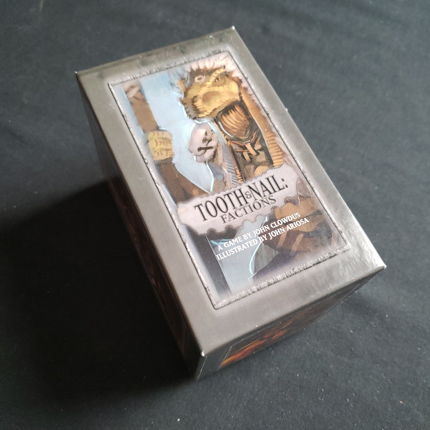 Image shows the front cover of the box of the Tooth and Nail: Factions card game
