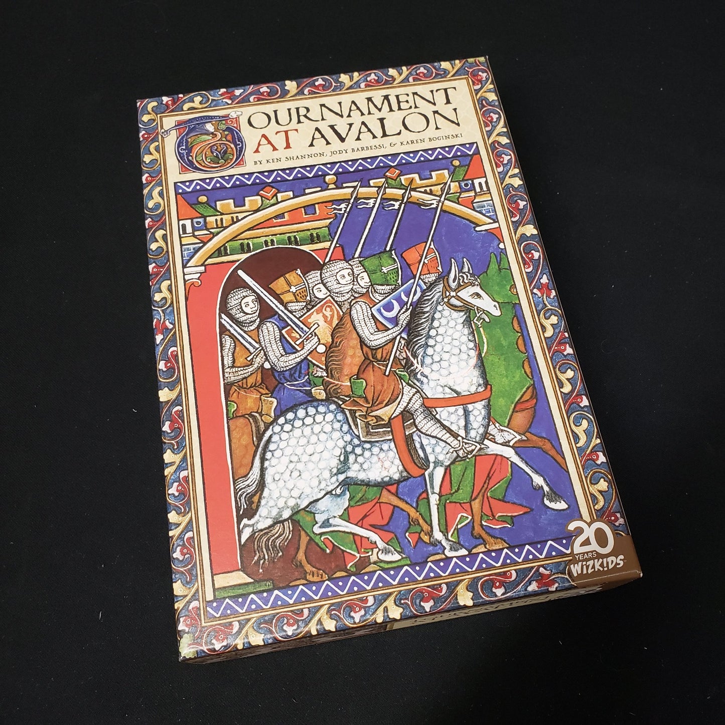 Image shows the front cover of the box of the card game Tournament At Avalon