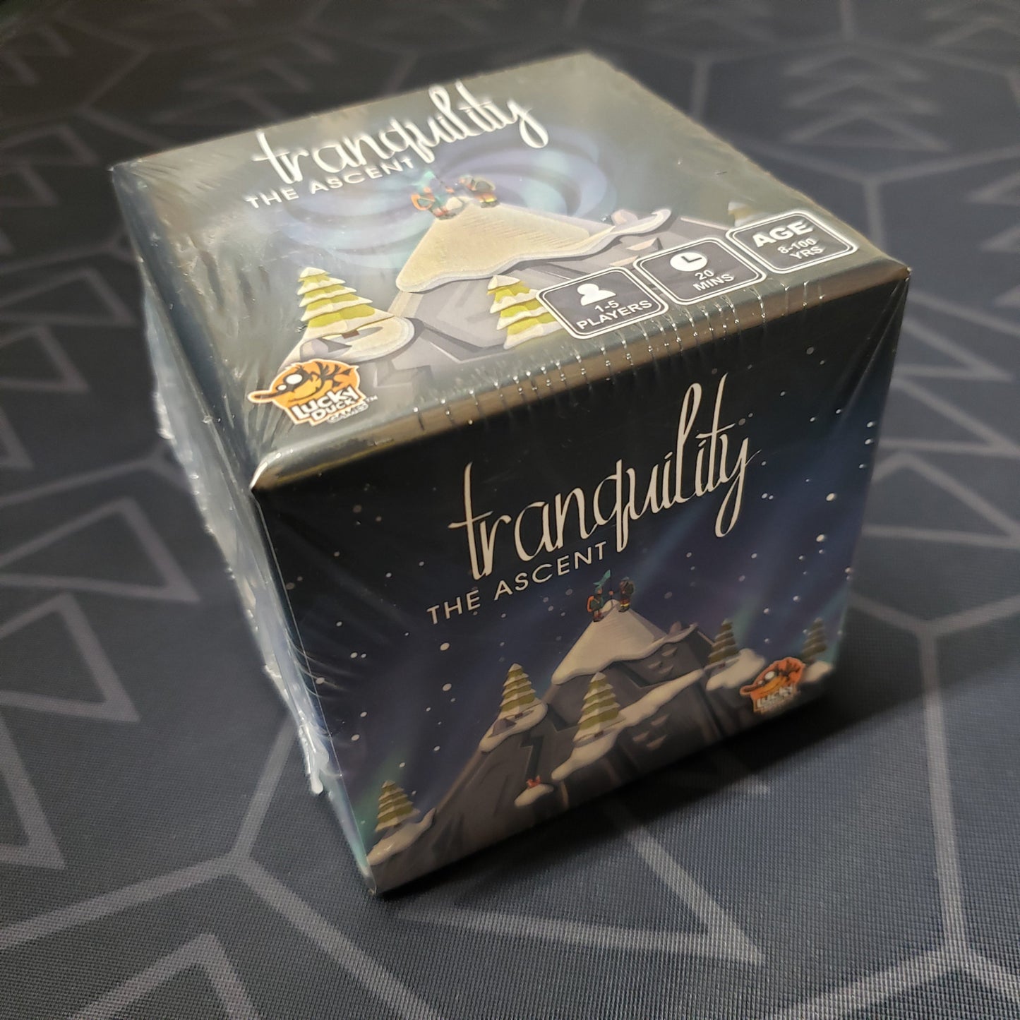 Image shows the front cover of the box of the card game Tranquility: The Ascent