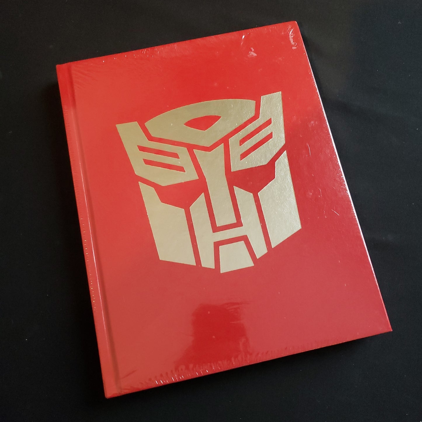 Image shows the front cover of the Deluxe Limited Edition of the Core Rulebook for the Transformers roleplaying game