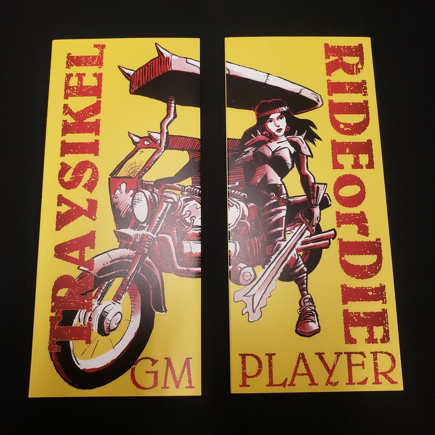 Image shows the front of the two pamphlets that make up the Traysikel: Ride or Die roleplaying game
