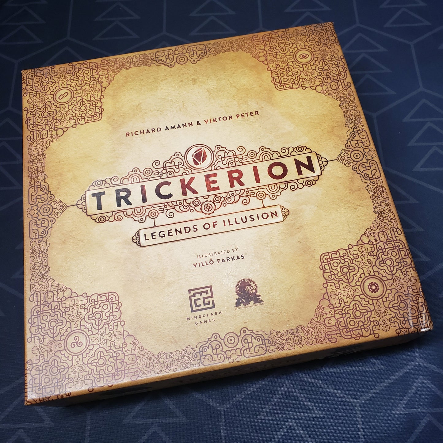 Image shows the front cover of the box of the Trickerion: Legends of Illusion board game