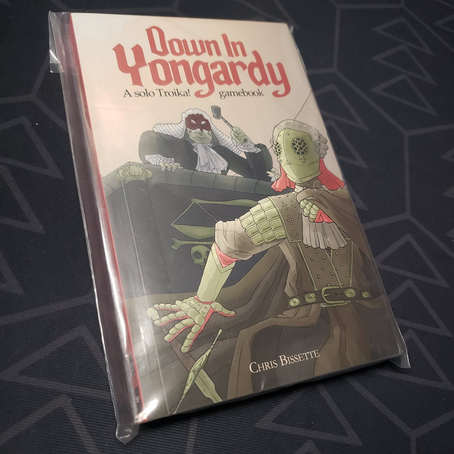 Image shows the front cover of the TROIKA!: Down in Yongardy roleplaying game book