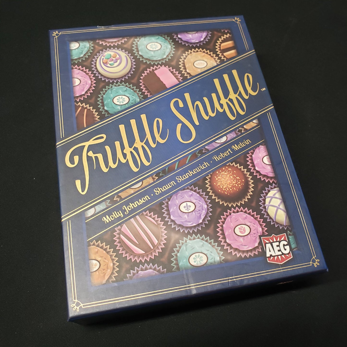 Image shows the front cover of the box of the Truffle Shuffle card game