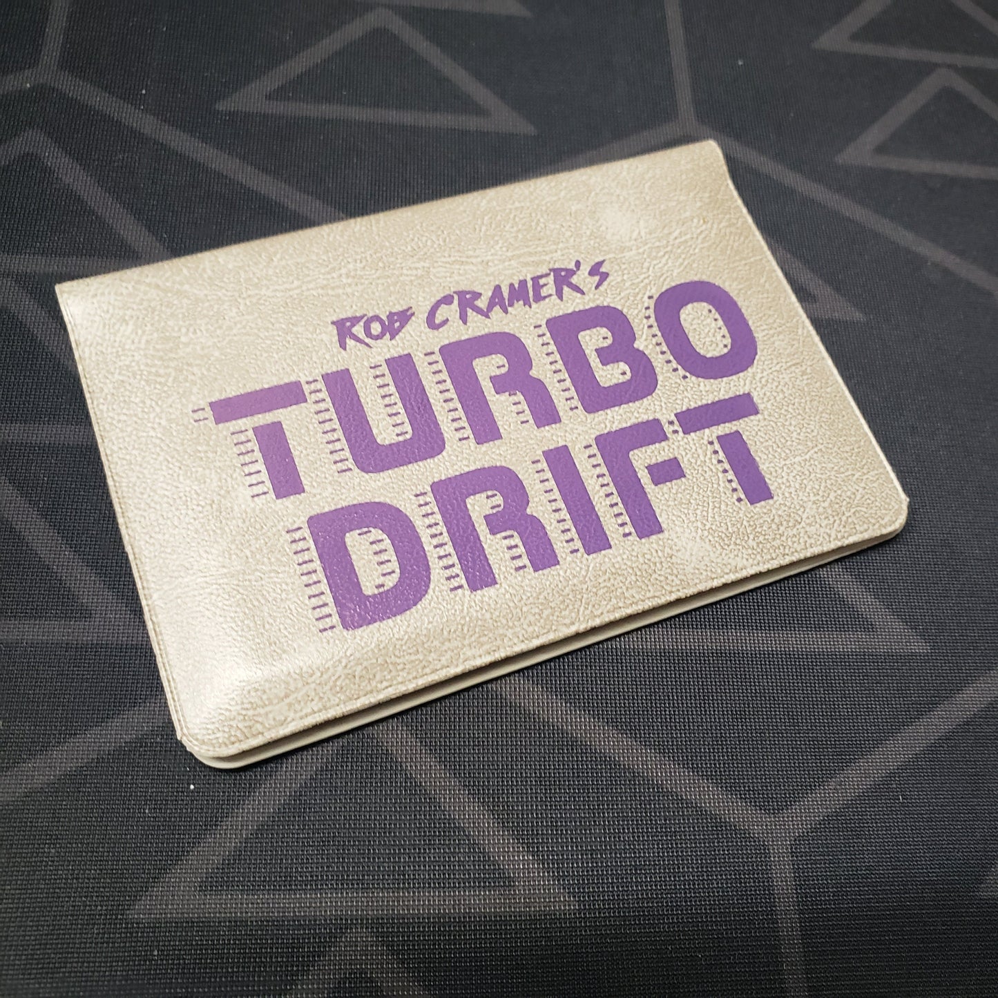 Image shows the front of the card wallet for the Turbo Drift card game