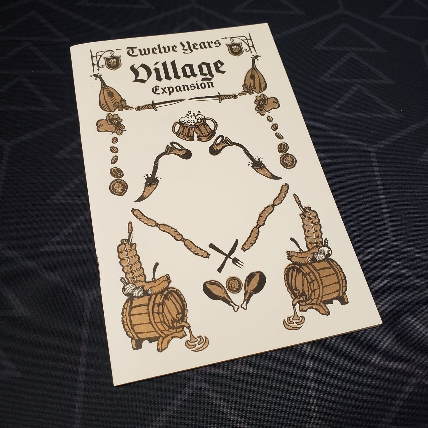 Image shows the front cover of the Village expansion book for the Twelve Years roleplaying game