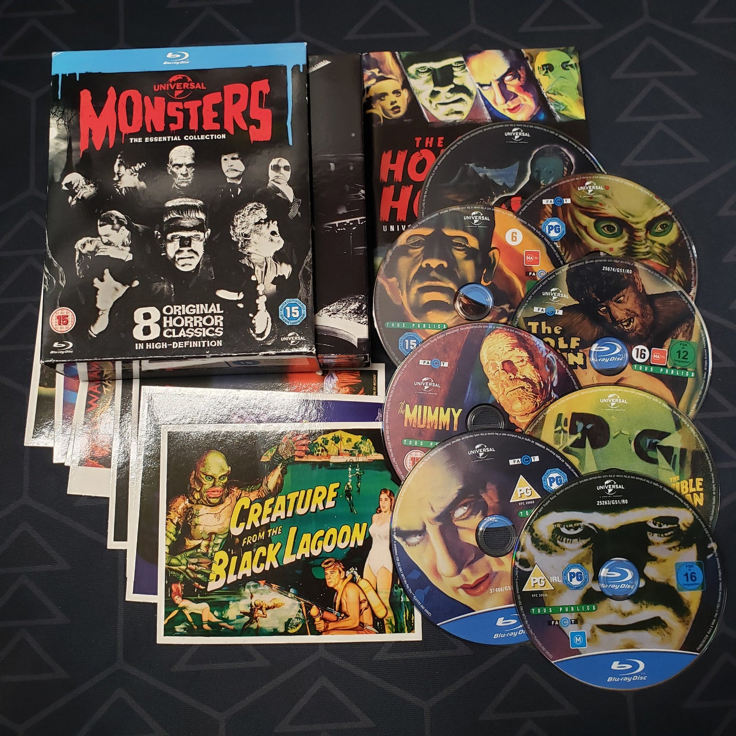 Image shows the case, inserts & eight discs for the movie set of Universal Monsters: The Essential Collection on Blu-Ray