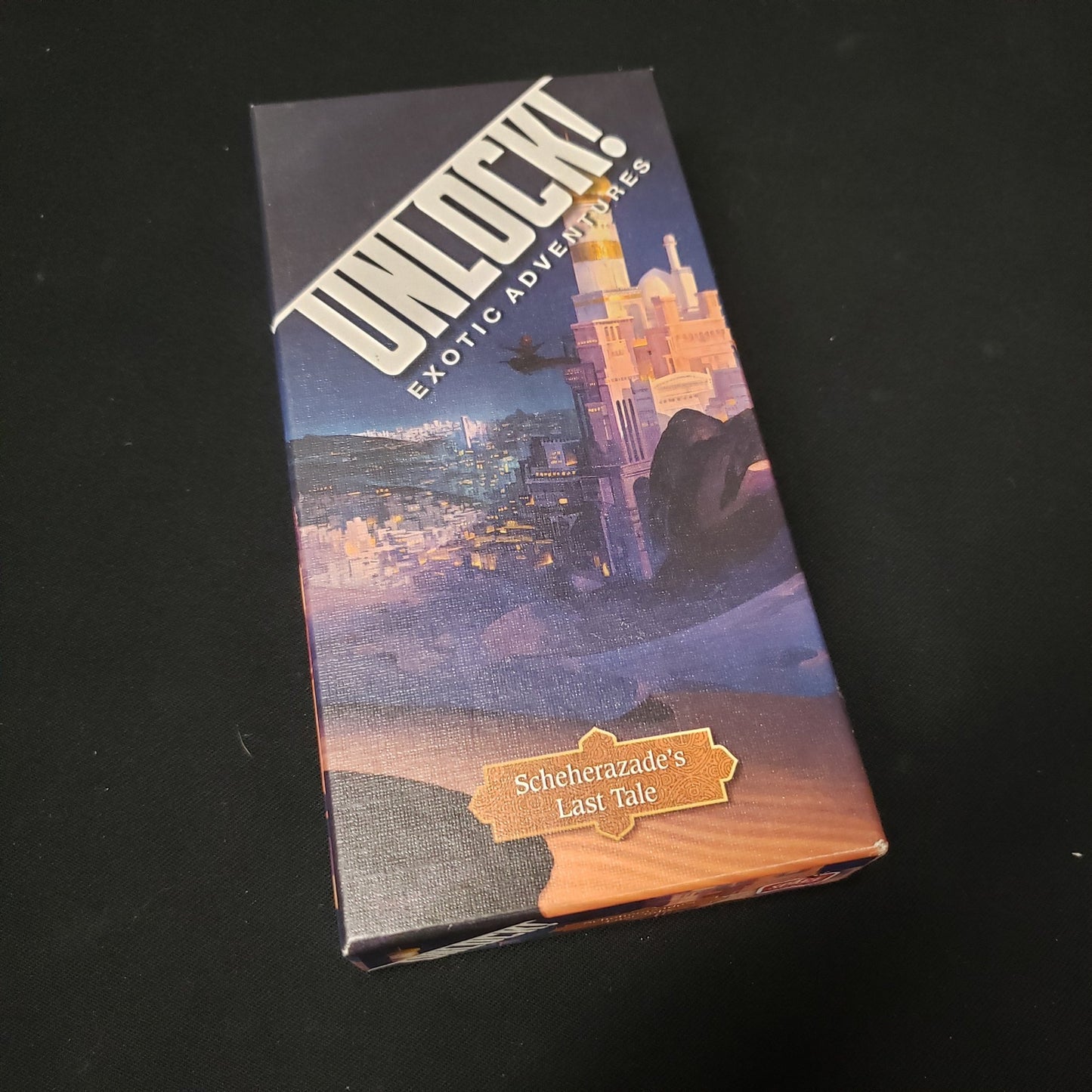 Image shows the front cover of the box of the card game Unlock!: Scheherazade's Last Tale
