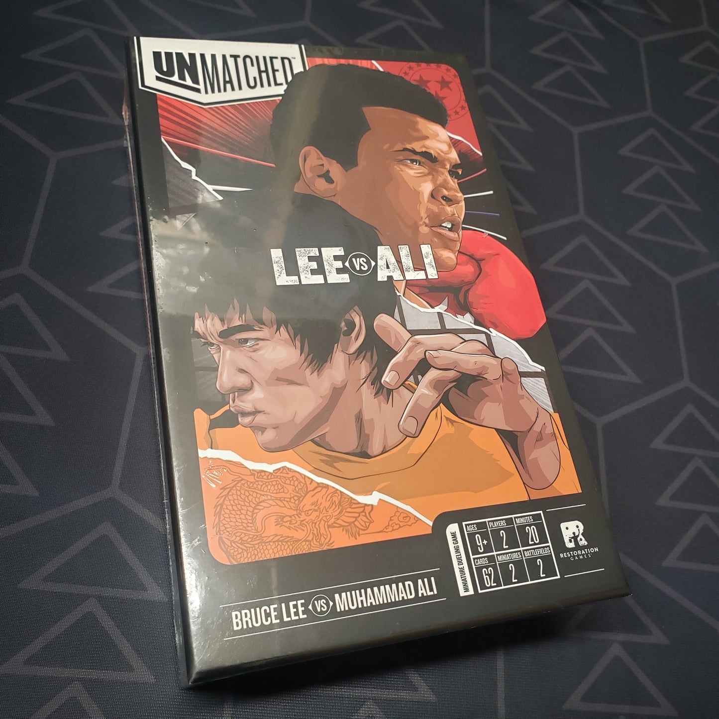 Image shows the front cover of the box for the Unmatched: Muhammad Ali vs. Bruce Lee board game