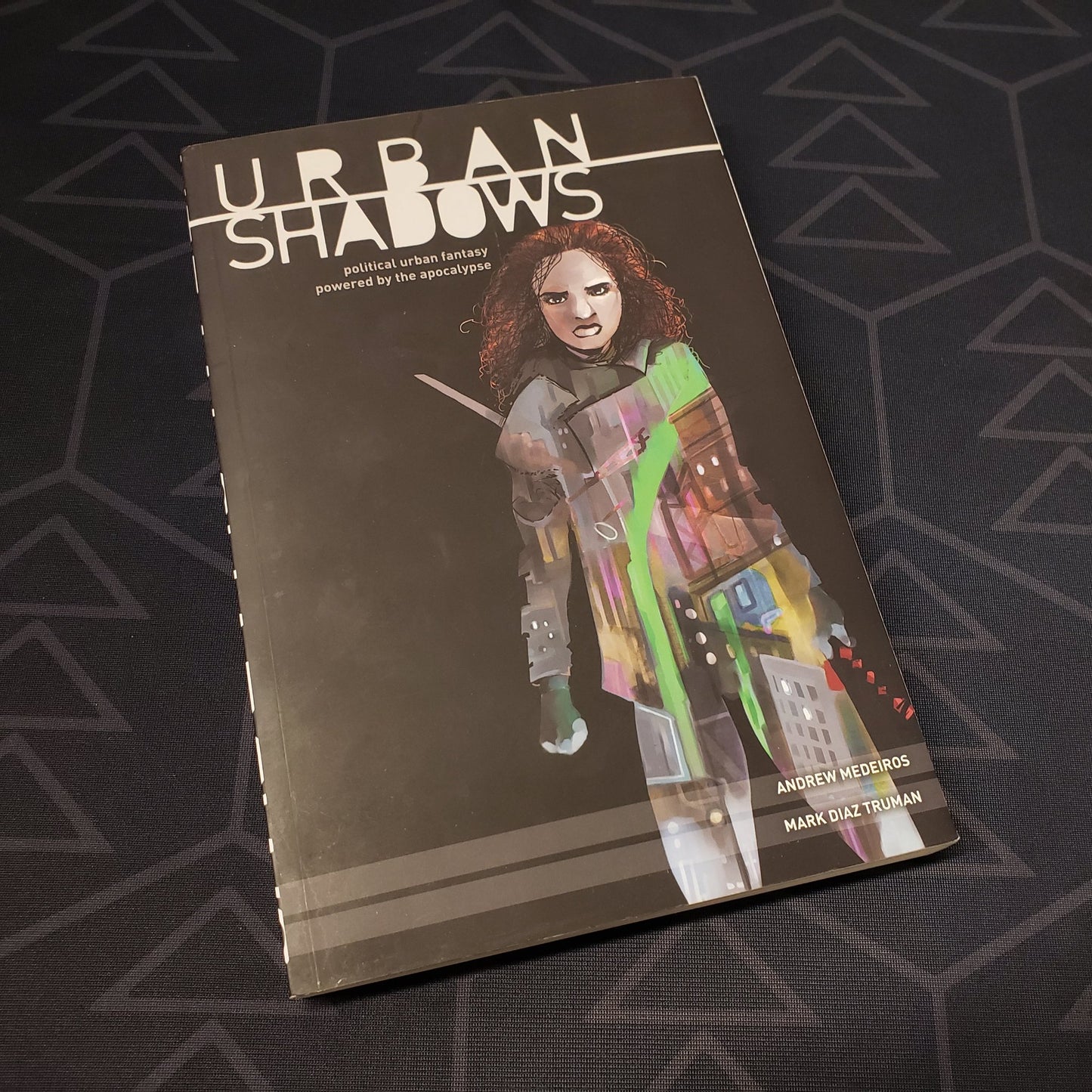 Image shows the front cover of the Urban Shadows 1E roleplaying game book