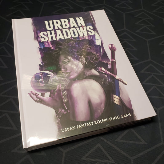 Image shows the front cover of the core rulebook for the roleplaying game Urban Shadows: Second Edition