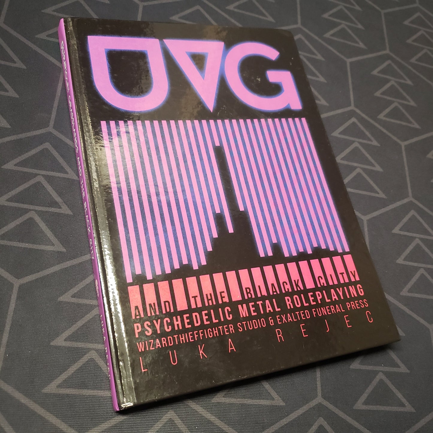 Image shows the front cover of the UVG and the Black City roleplaying game book