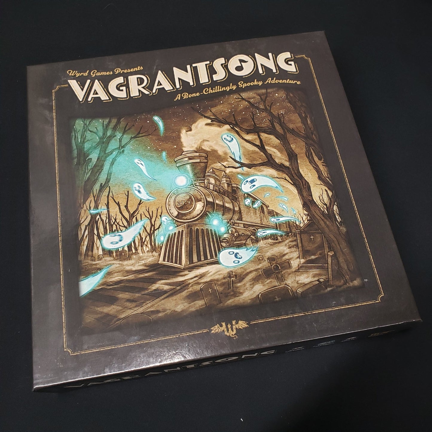 Image shows the front cover of the box of the Vagrantsong board game