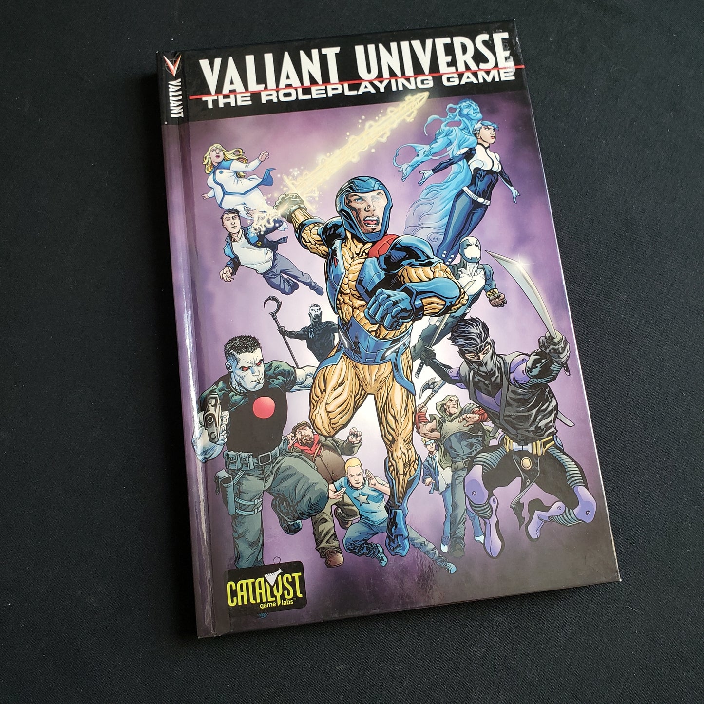 Image shows the front cover of the core rulebook for the Valiant Universe roleplaying game