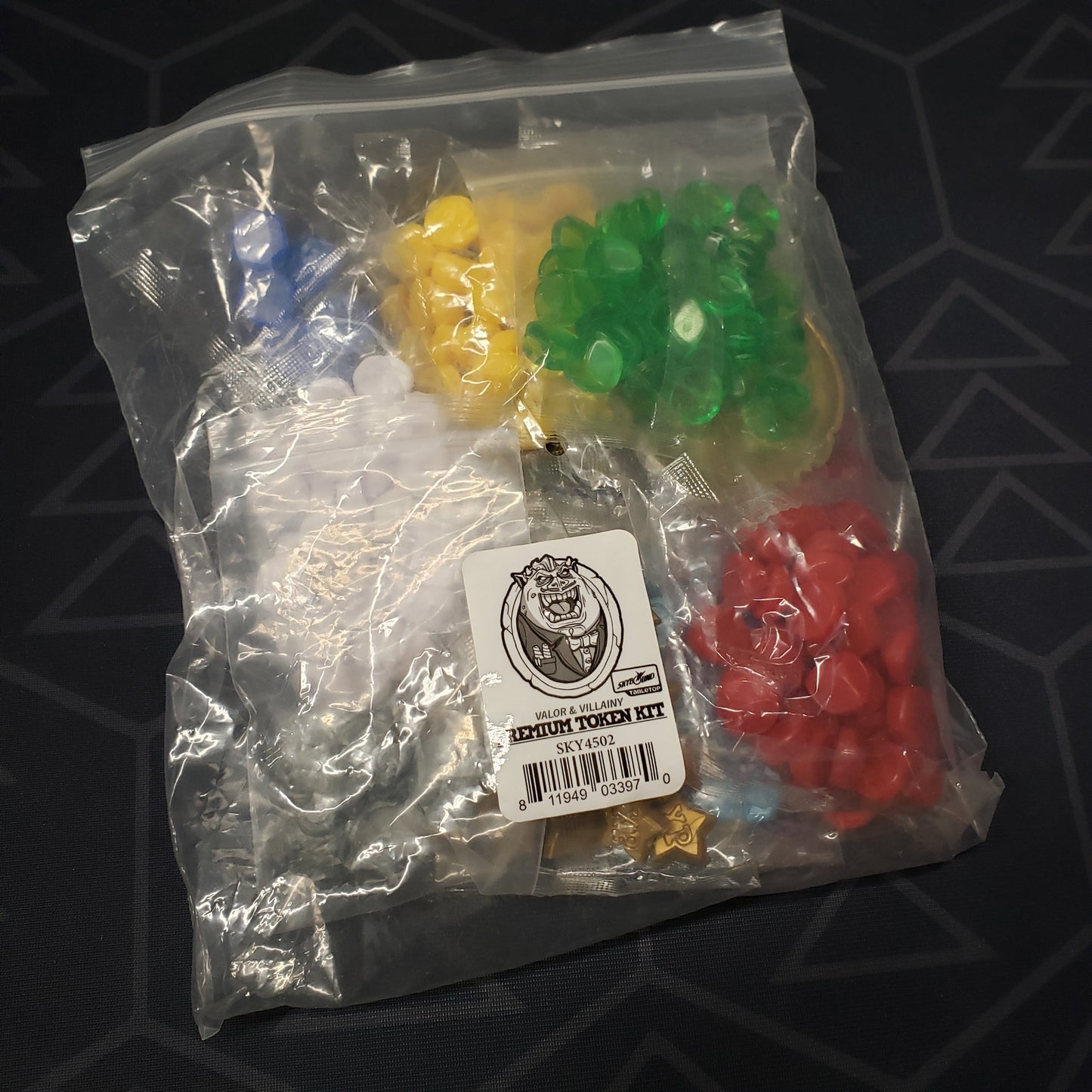 Image shows the front of the package of the Premium Token Set for the board game Valor & Villainy