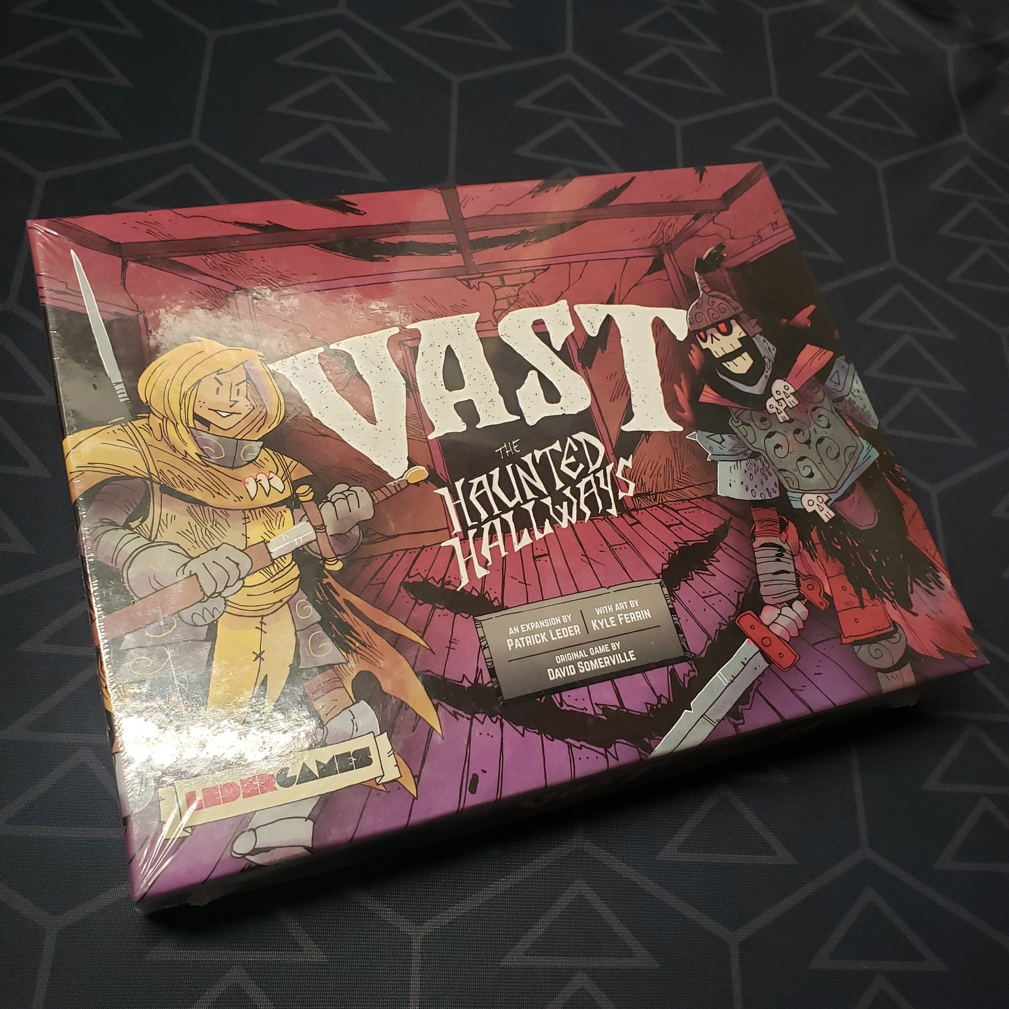 Image shows the front cover of the box of the Haunted Hallways expansion for the board game Vast: Mysterious Manor