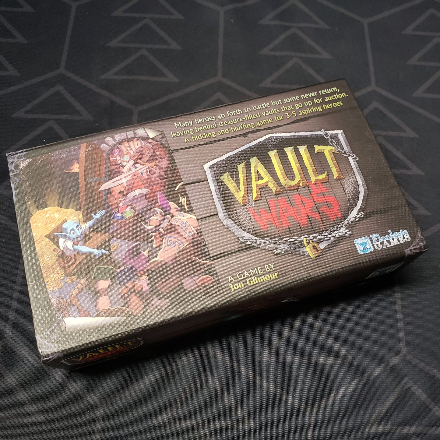 Image shows the front cover of the box of the Vault Wars card game