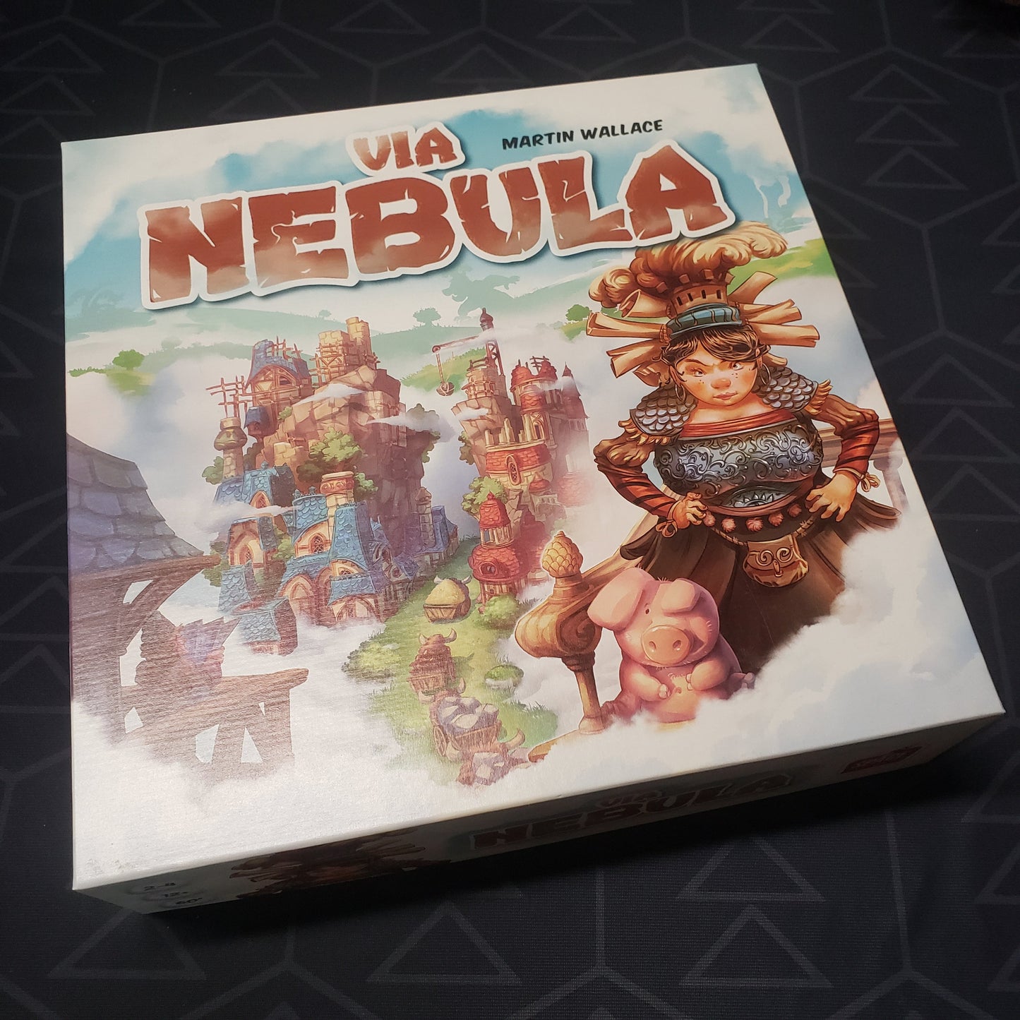 Image shows the front cover of the box of the Via Nebula board game