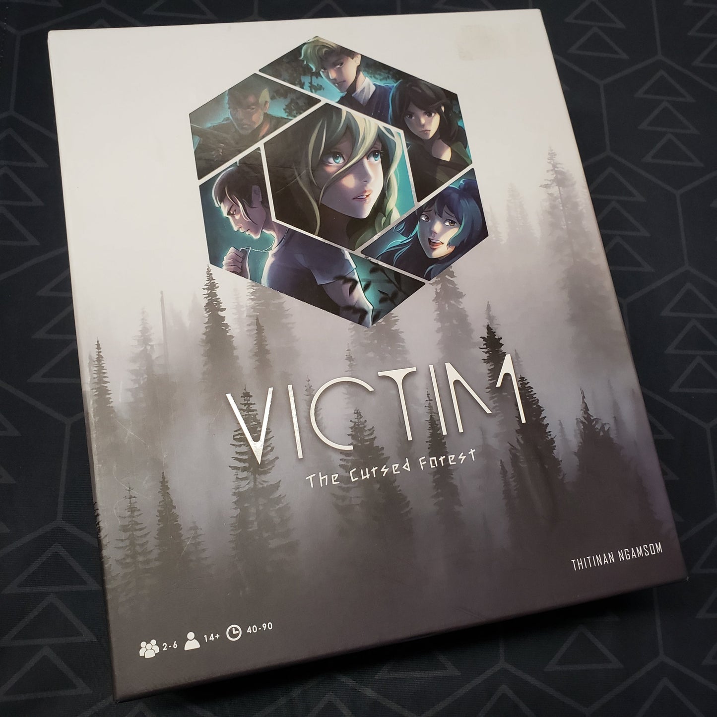 Image shows the front cover of the box for the board game Victim: The Cursed Forest