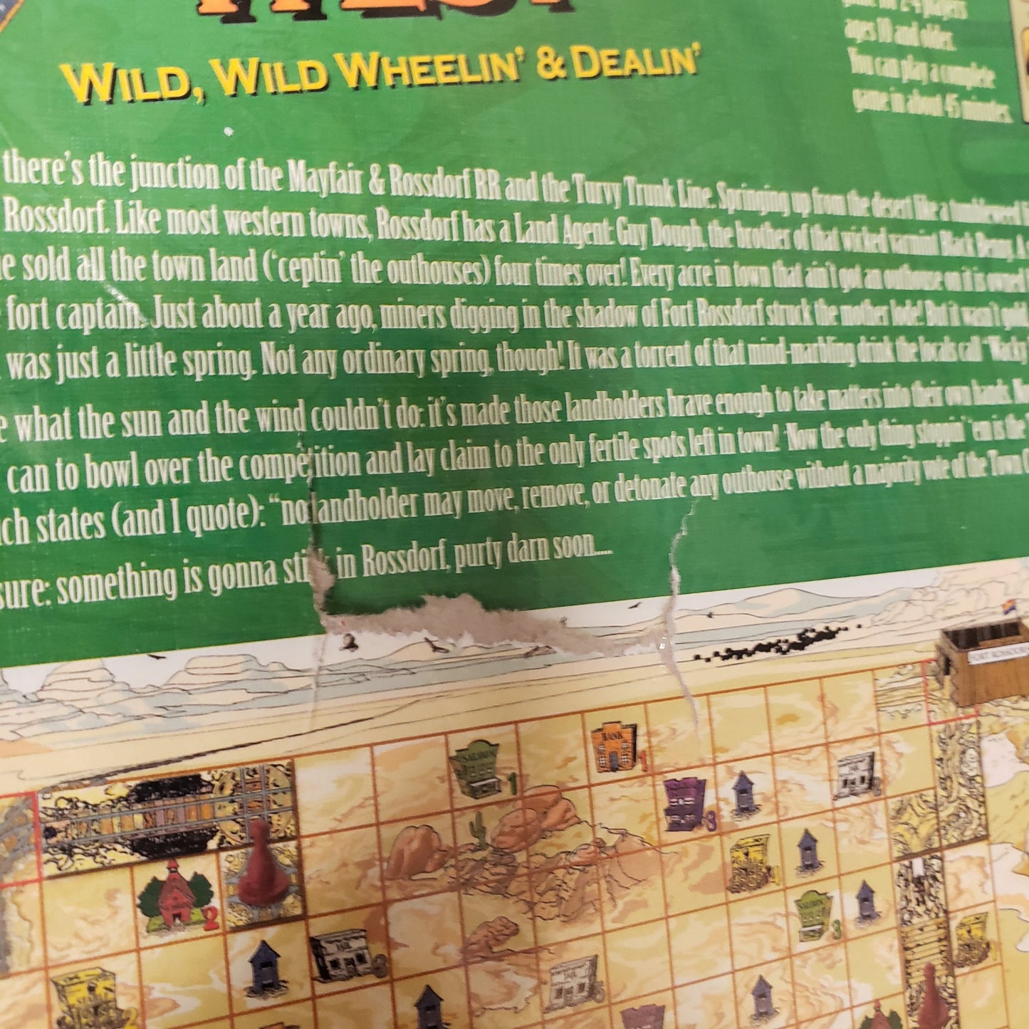 Image shows damaged to the back of the box of the Wacky Wacky West board game