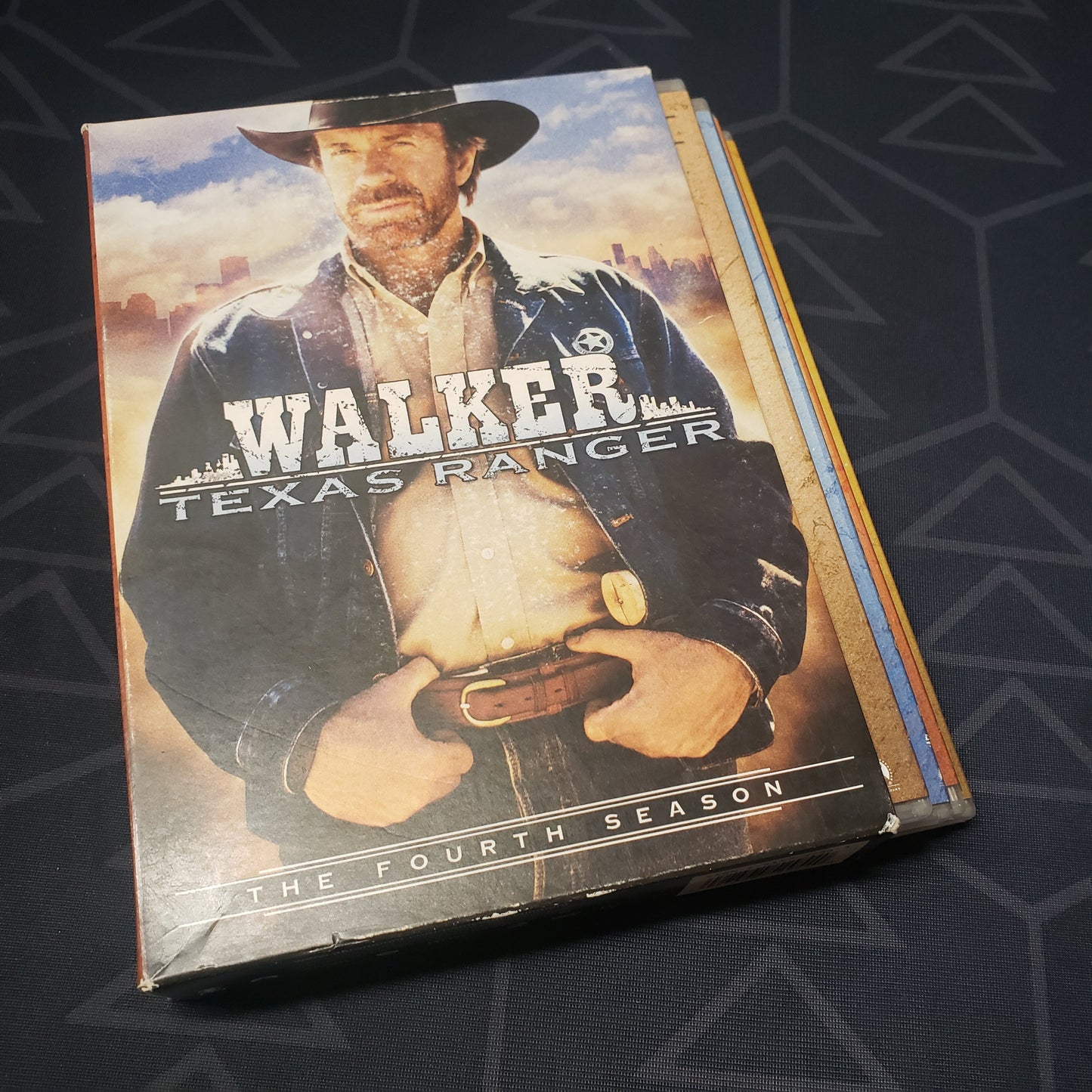 Image shows the front of the outer box & four fanned-out disc cases for the fourth season of Walker, Texas Ranger on DVD