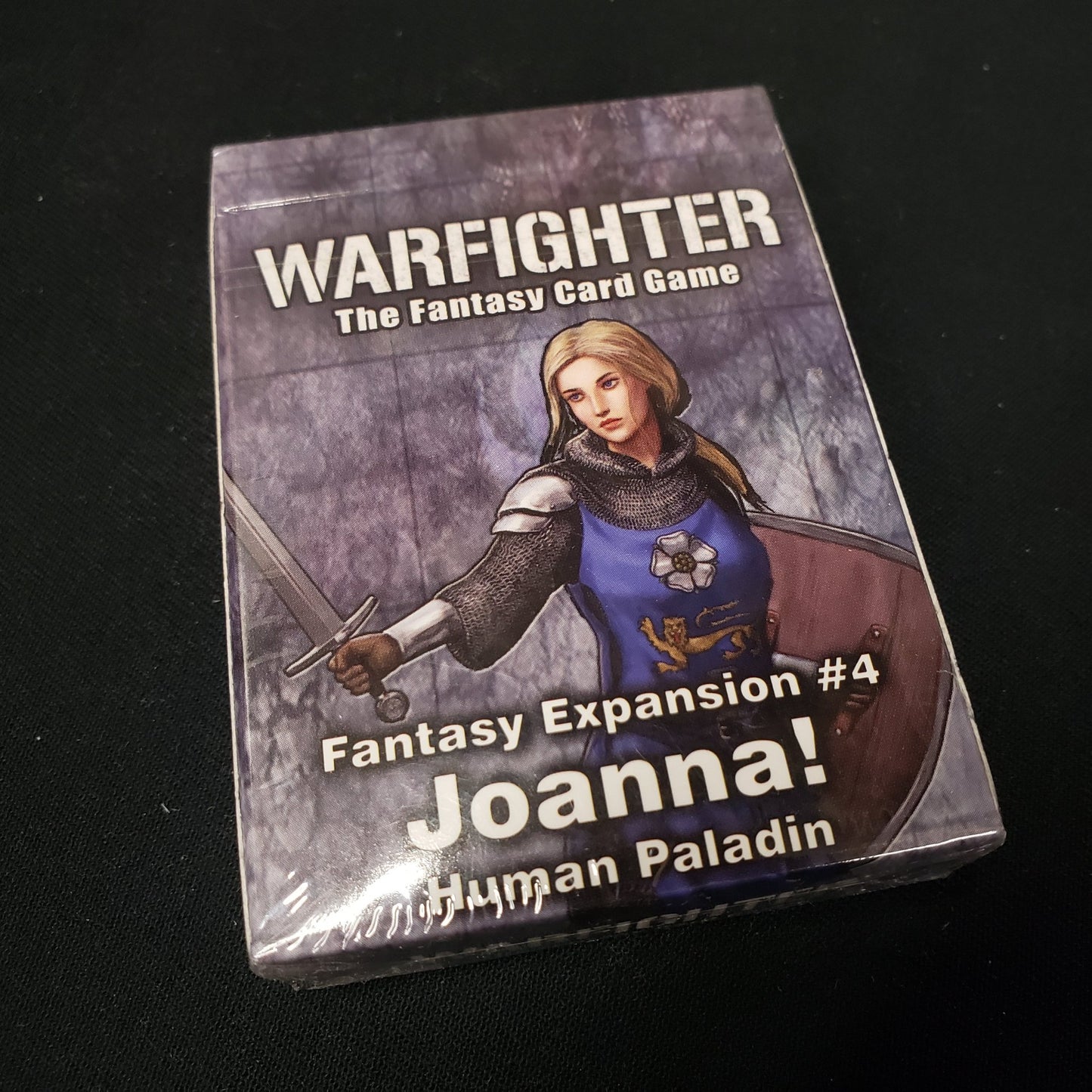 Image shows the front of the package for the Joanna Expansion Pack for the Warfighter: Fantasy card game