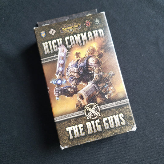 Image shows the front cover of the box of the Big Guns expansion for the card game Warmachine: High Command