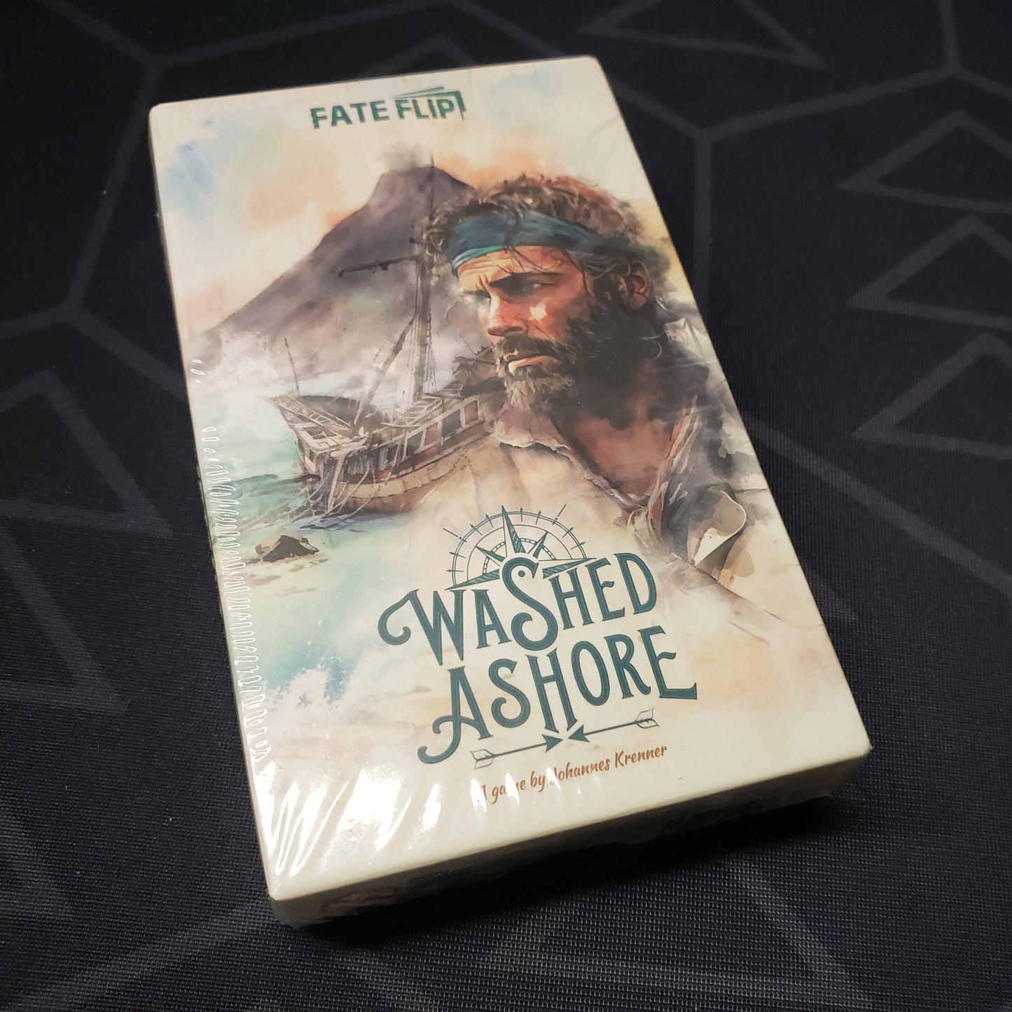 Image shows the front cover of the box of the Washed Ashore card game