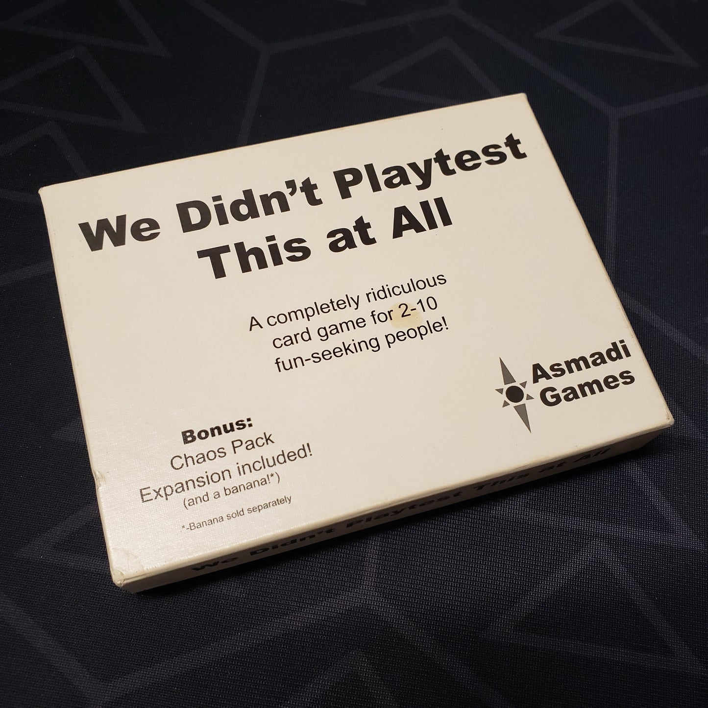 Image shows the front cover of the box of the card game We Didn't Playtest This at All