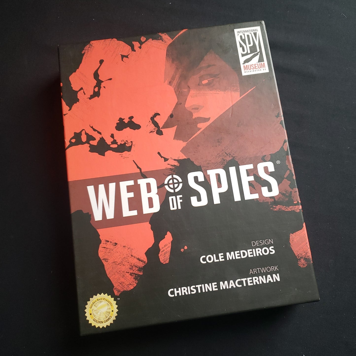 Image shows the front cover of the box of the Web of Spies board game