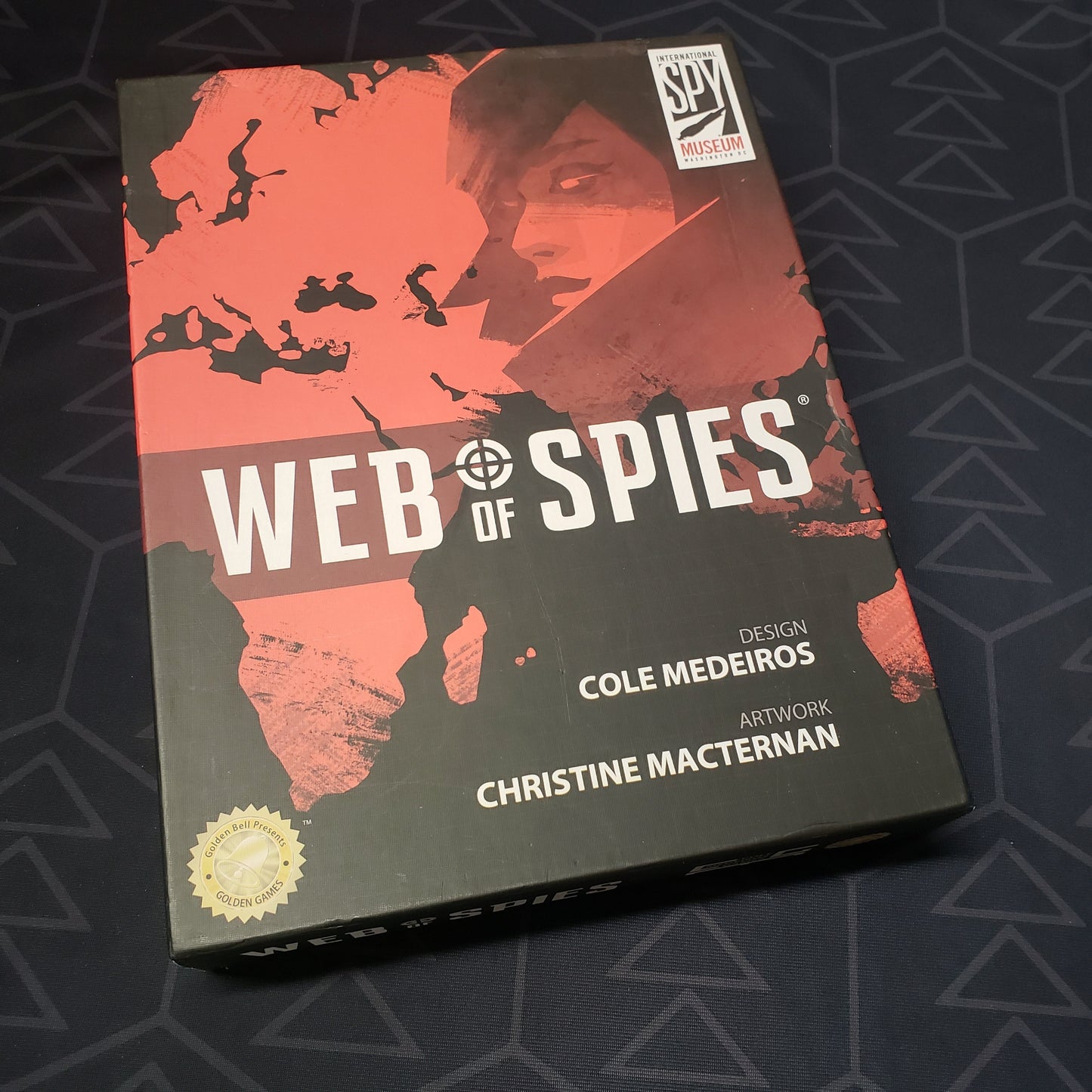 Image shows the front cover of the box of the Web of Spies board game