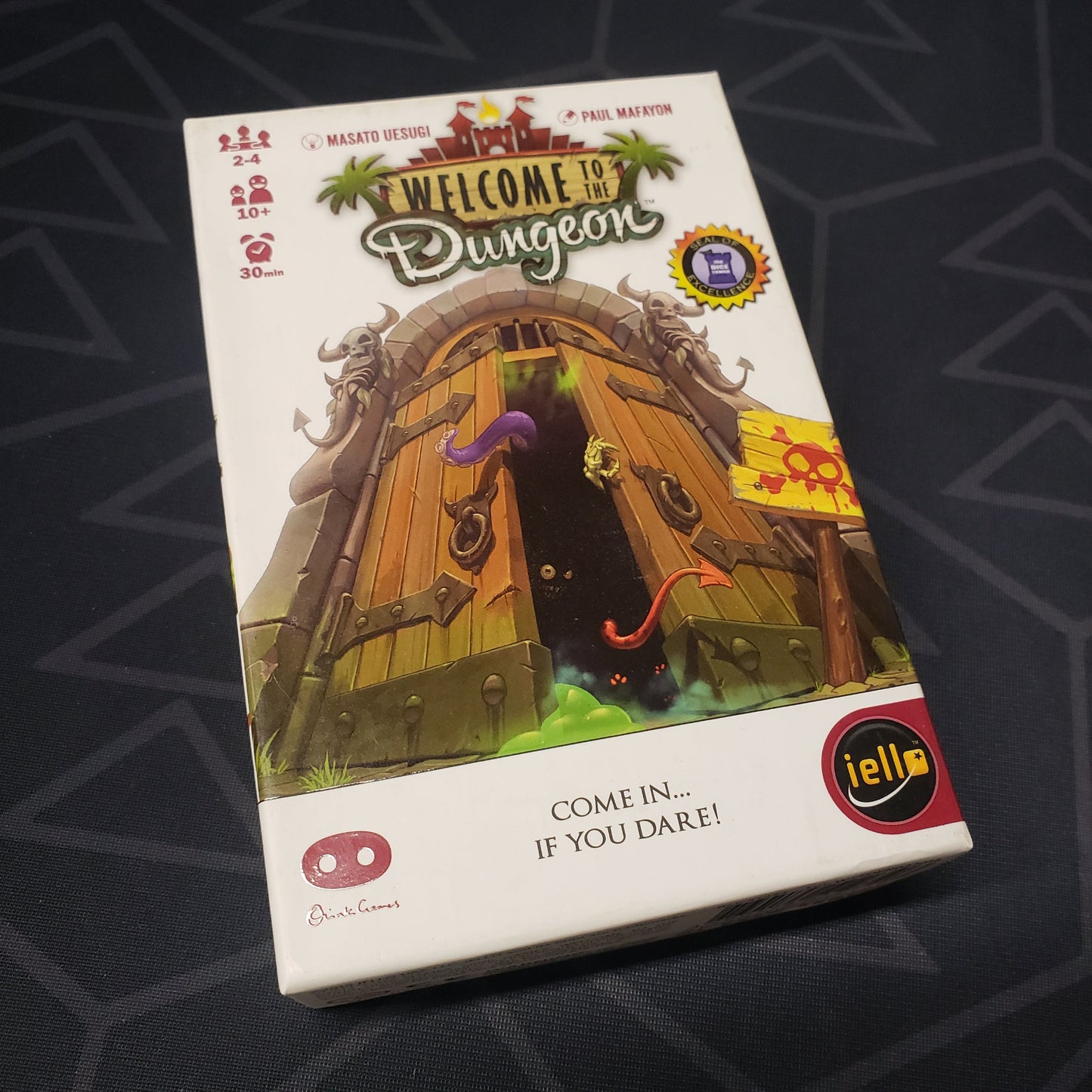 Image shows the front cover of the box of the Welcome to the Dungeon card game