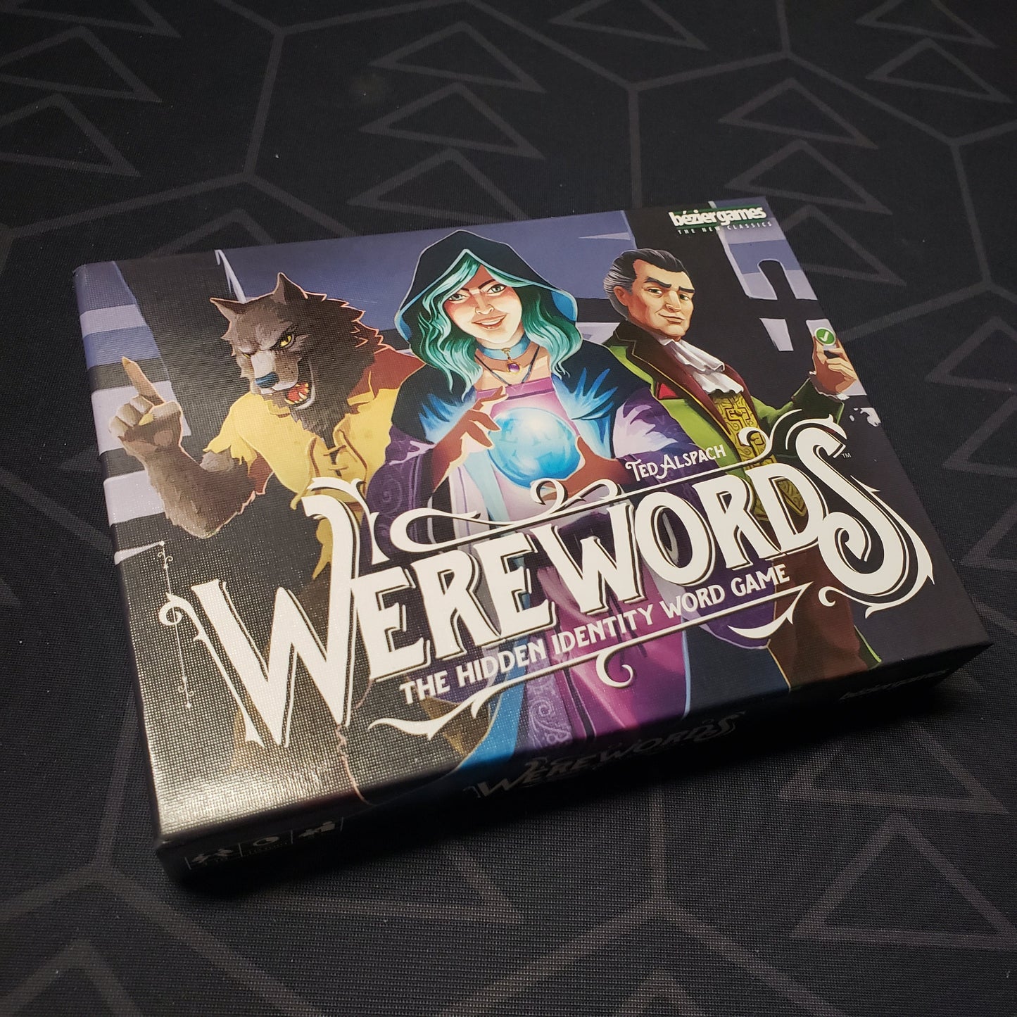 Image shows the front cover of the box of the Werewords card game