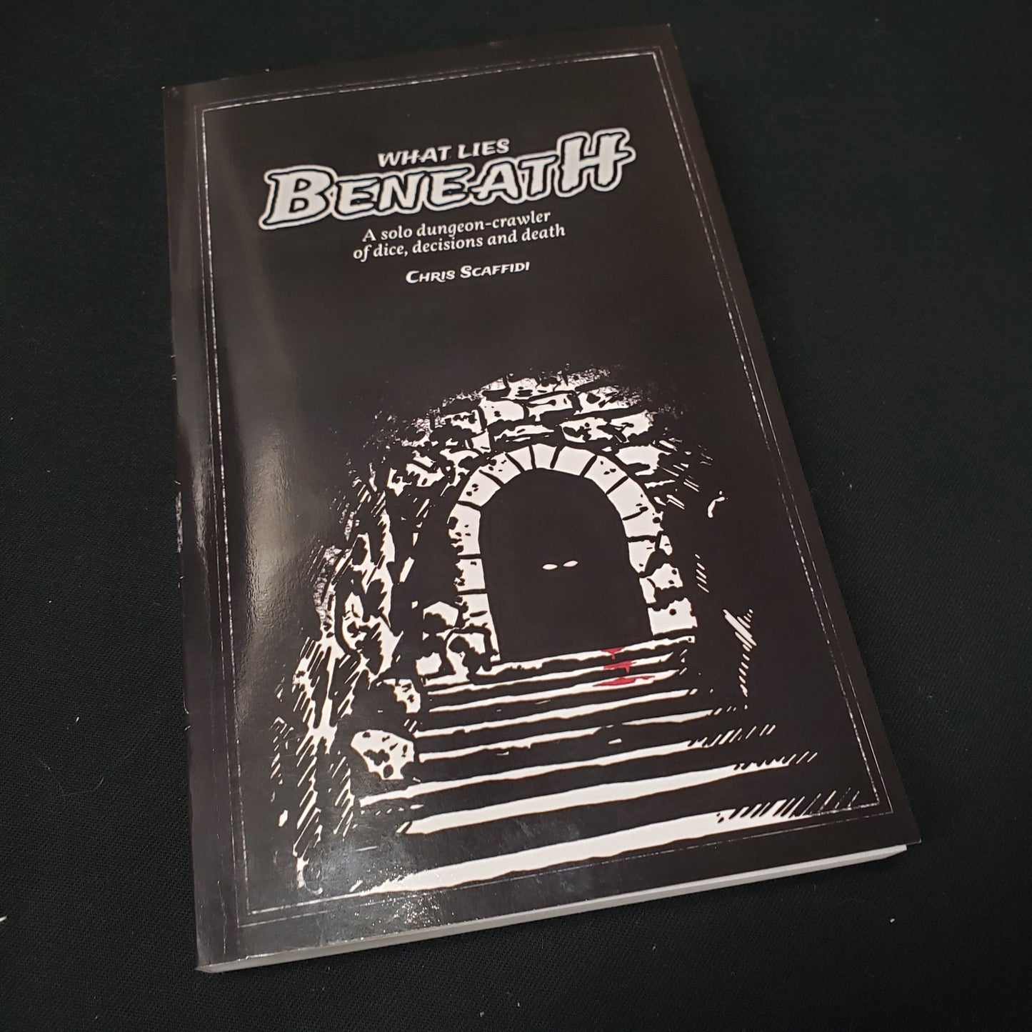 Image shows the front cover of the What Lies Beneath roleplaying game book