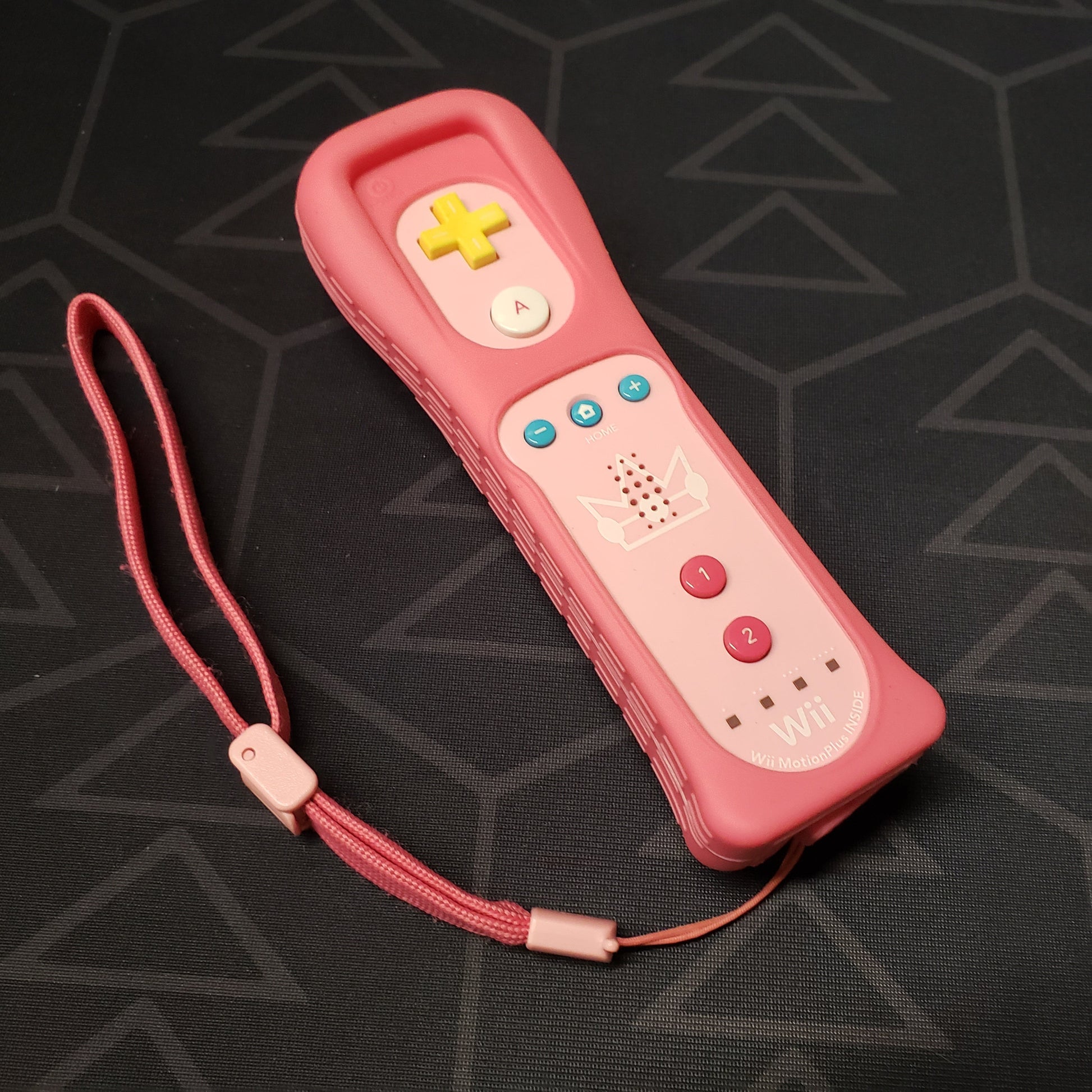 Image shows the top of a pink Princess Peach MotionPlus controller for Nintendo Wii