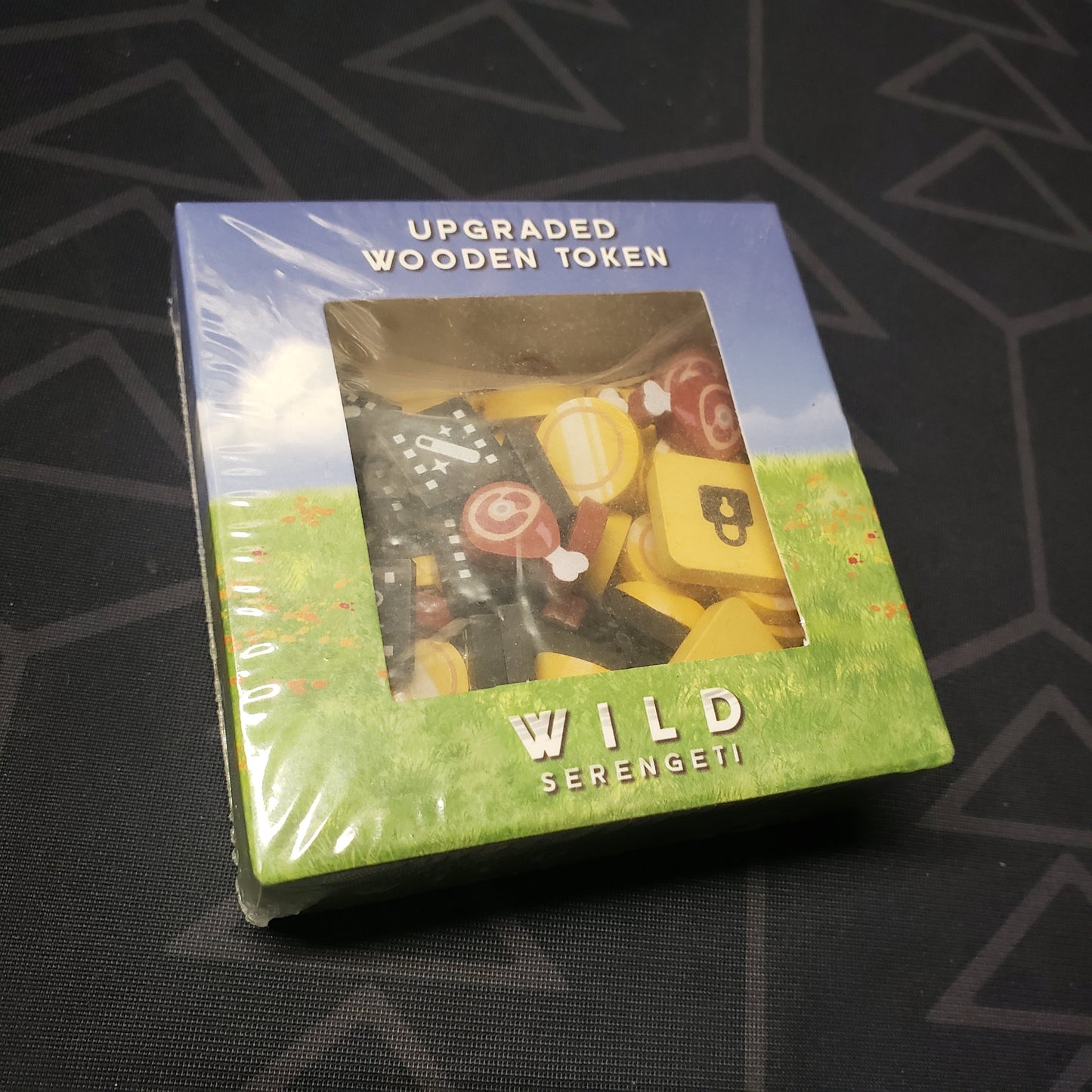 Image shows the front cover of the box for the Upgraded Wooden Tokens pack for the board game Wild: Serengeti
