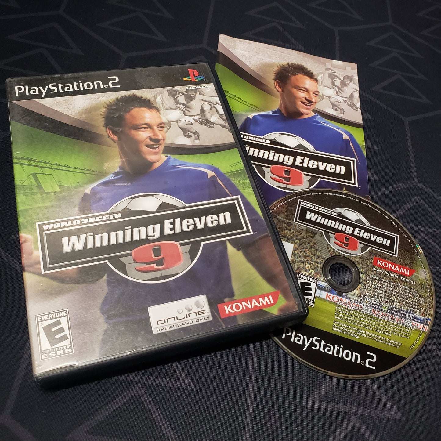 Image shows the case, manual and disc for the video game Winning Eleven 9 for Playstation 2