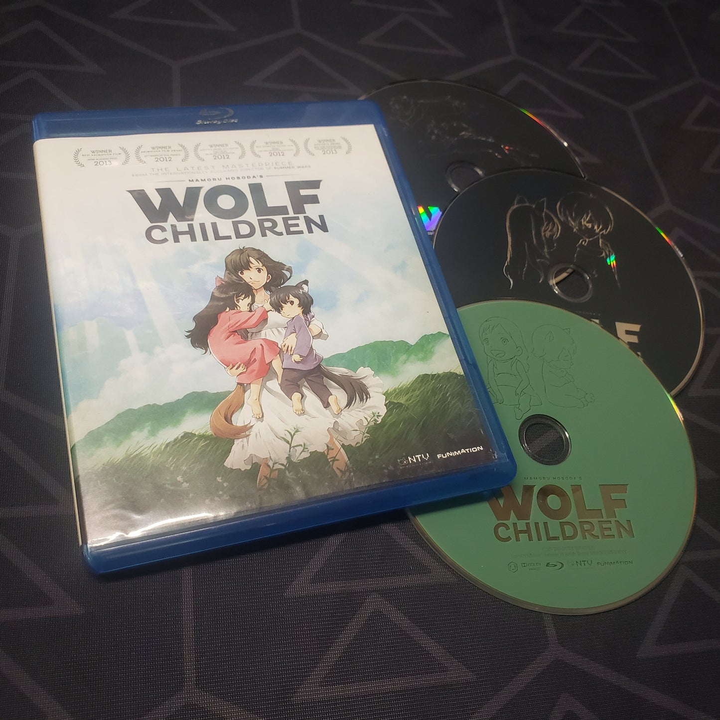 Image shows the case & three discs for the movie Wolf Children on Blu-Ray + DVD