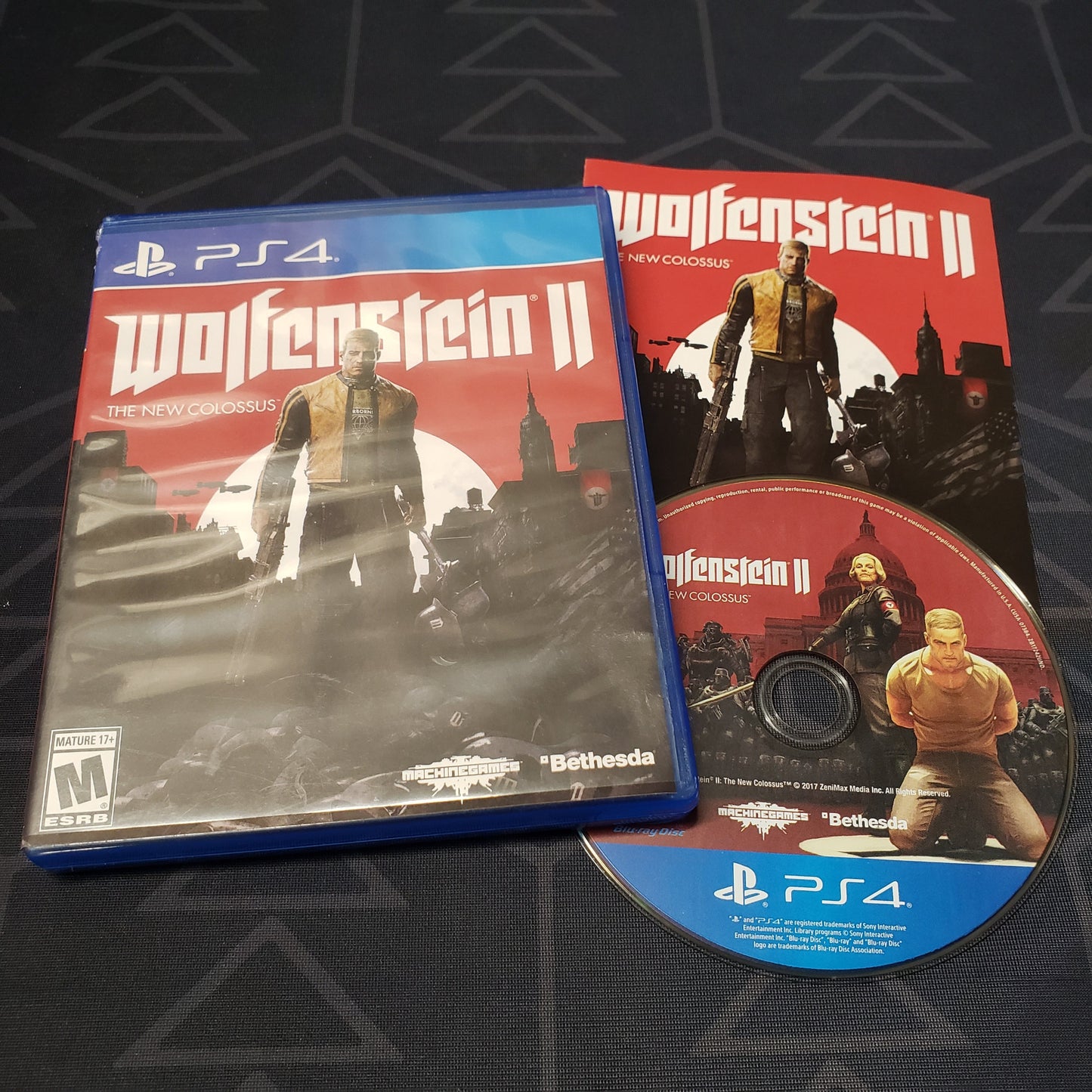 Image shows the case, manual and disc for the video game Wolfenstein II: The New Colossus for Playstation 4