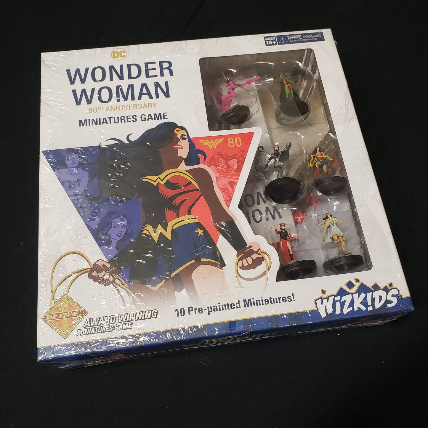 Image shows the front cover of the box of the Wonder Woman: 80th Miniatures Game